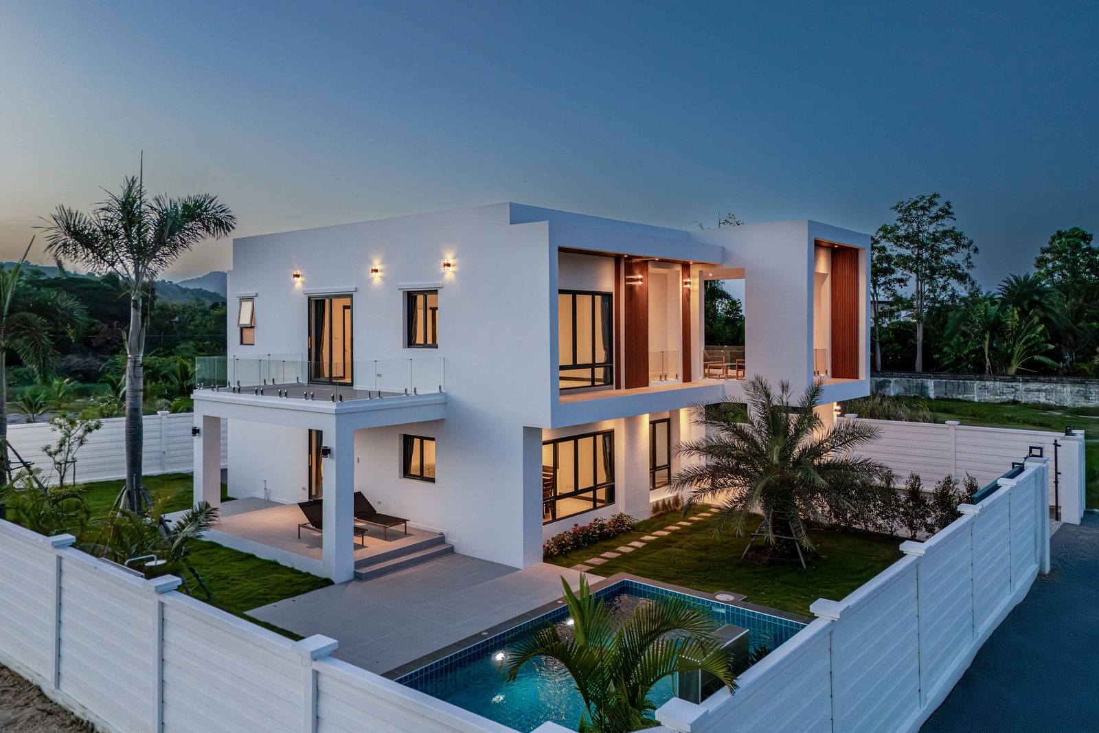 The same house at dusk with the interior lights on, Soi 102