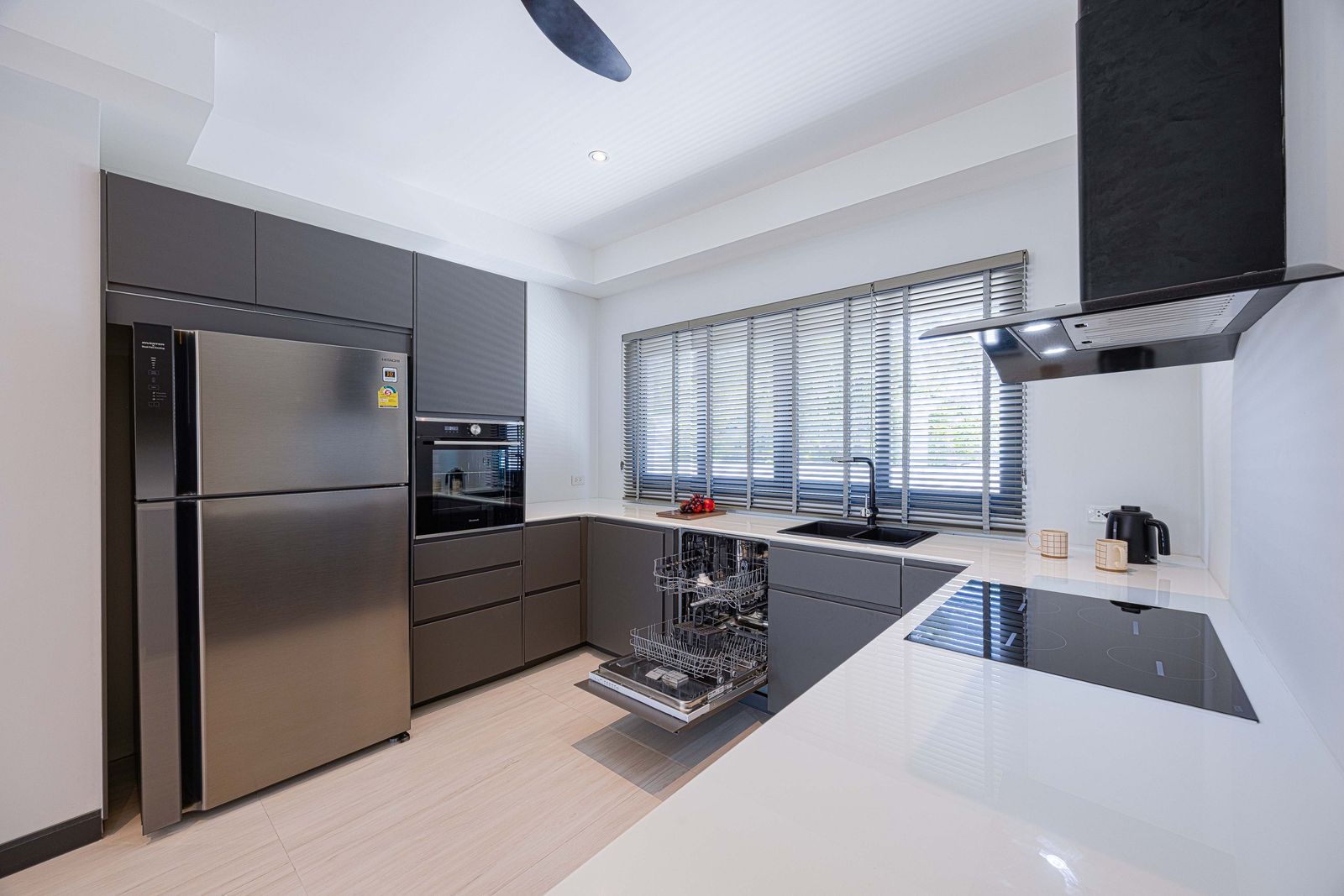 Fitted kitchen with dark cabinets and white worktops, Soi 102